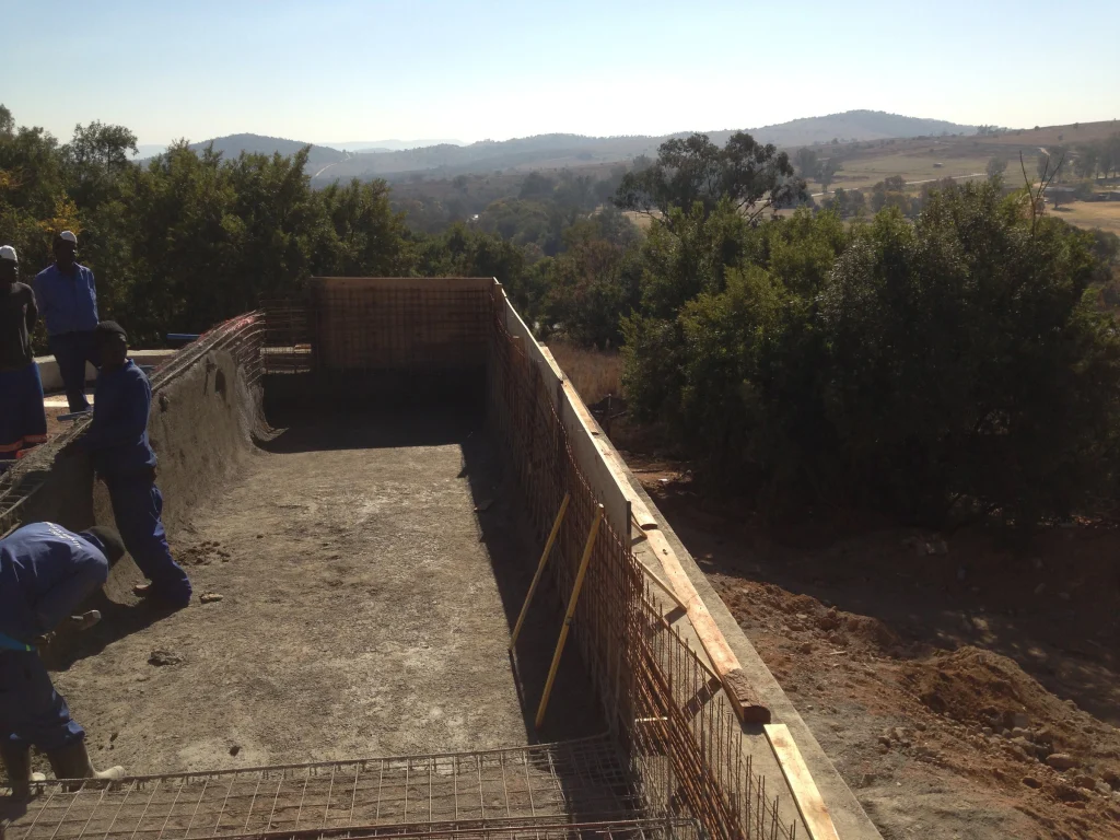 Raised infinity pool over the veld — during construction